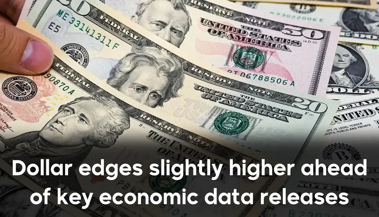 Dollar edges slightly higher ahead of key economic data releases